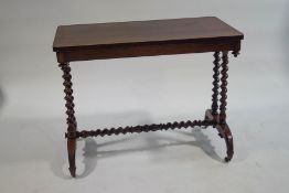 A Victorian rosewood centre table with barley twist supports,