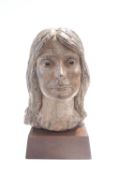 A contemporary pottery bust of woman's head, on a wooden plinth,