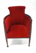 An Edwardian tub chair in red upholstery