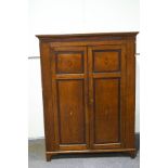 An early 19th Century oak two door cupboard with mahogany cross band,