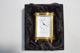 A Mappin & Webb brass oval carriage clock, 15.