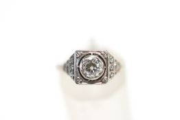 A diamond ring, circa 1925, stamped 'Plat', the old brilliant cut of approximately 0.