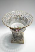 A 20th century Dresden porcelain comport with pierced bowl, encrusted with flowers,