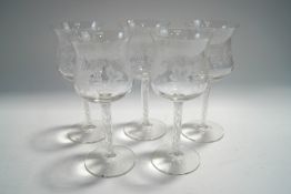 Five 20th century claret glasses, the bowls engraved with fruiting vines, upon opaque twist stems,