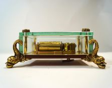 A Reuge of Switzerland glass music box, with brass rosette mounts and dolphin feet,
