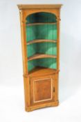 A pine standing corner cabinet with panelled door, 190cm high,
