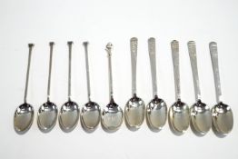 A silver coffee spoon with a golf ball finial; with a set of five silver coffee spoons;