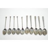 A silver coffee spoon with a golf ball finial; with a set of five silver coffee spoons;