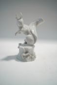 A Meissen blanc de chine figure of a squirrel, impressed and painted cross swords mark, 14.