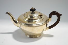 A silver teapot, by H.