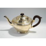 A silver teapot, by H.