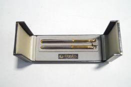 An Elysee fountain pen and ballpoint pen set, with engine turned case,