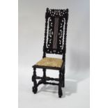 A 17th century Scottish oak chair with later replacements, the back with inset cane panel,