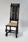 A 17th century Scottish oak chair with later replacements, the back with inset cane panel,