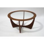 A mid 20th century G-plan circular coffee table, with glass inset top,