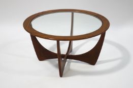 A mid 20th century G-plan circular coffee table, with glass inset top,