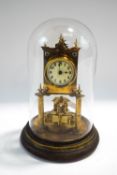 An early 20th century brass torsion clock (400 day), with stand and glass dome,