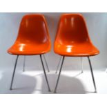 A pair of mid 20th century Herman Miller plastic fibreglass chairs,