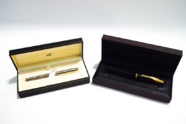 A Dunhill fountain pen with 18K medium nib, and a Dunhill fountain pen,