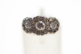 A triple cluster diamond ring, unmarked, the graduated brilliant cuts totalling approximately 0.