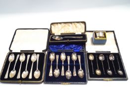 A cased set of six silver bean end coffee spoons; a cased set of six silver tea spoons;