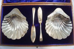 A pair of Edwardian silver shell shaped butter dishes, H.