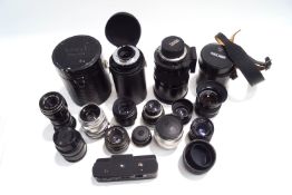 A collection of thirteen SLR camera lenses, cases and accessories, including Zeiss, Ikon, Paragon,