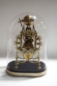 A fusee brass skeleton clock with passing strike on a bell, under a glass dome,
