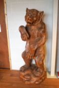 A Black Forest style carved bear on rocky base,