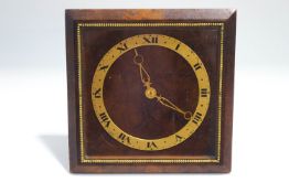 A burr walnut strut clock with brass chapter dial and beaded surround,