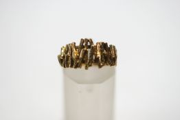 A 9 carat gold textured ring, finger size K, 3.