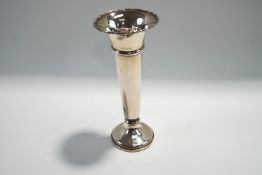 A loaded silver bud vase, London 1919, of usual plain trumpet form, 22.