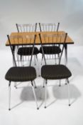 A set of four 1960's chrome dining chairs with padded seats,