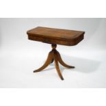 A Regency mahogany card table, the rosewood crossbanded top enclosing a green baize lining,