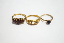 A 9 carat gold garnet dress ring; with a 9 carat gold onyx ring; 3.