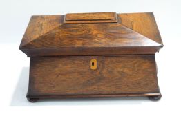 A 19th century rosewood tea caddy of sarcophagus form, the interior with two lidded compartments,