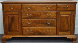 An American cherrywood sideboard, with six drawers flanked by cupboards,