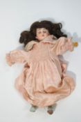 A German bisque headed doll, impressed marks to the neck,