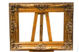 A large modern gilded plaster picture frame,