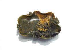 A Chinese carved green hardstone lotus leaf dish, 13.