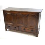 An 18th century mule chest with triple shaped panelled front above two short drawers with later