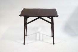 A mahogany coaching table with shaped folding top,