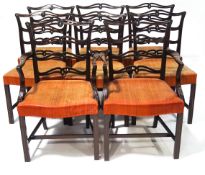 A set of eight George III style dining chairs with pierced ladder backs with stuff over seats