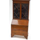 A 19th century mahogany bureau bookcase with two glazed doors above a fall front,