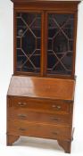 A 19th century mahogany bureau bookcase with two glazed doors above a fall front,