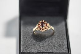 A 9 carat gold garnet cluster ring, finger size L1/2, 1.
