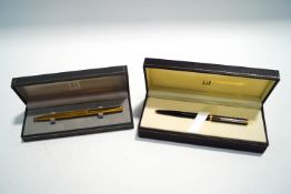 A Dunhill gold plated ballpoint pen, and a Dunhill black and 'gold' flecked ballpoint pen,