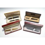 Four Sheaffer White Dot fountain pens, including a gold tone textured case pen with 14K nib,