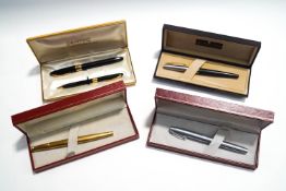 Four Sheaffer White Dot fountain pens, including a gold tone textured case pen with 14K nib,
