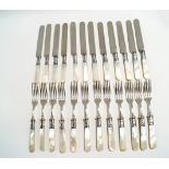 A set of twelve mother of pearl handled dessert knives and forks